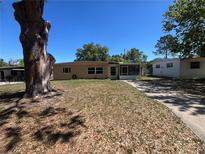 Charming single-story home with a well-maintained lawn and mature trees, offering a welcoming curb appeal at 1703 Doreen Ave, Ocoee, FL 34761