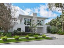Stunning contemporary home with a modern stone facade, lush landscaping, and a clean architectural design at 229 Alexander Pl, Winter Park, FL 32789