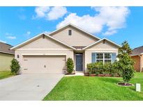 Charming single-story home featuring a two-car garage and a well-manicured lawn at 432 Tallow Wood Cir, Debary, FL 32713