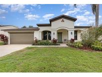 Charming single-story home with a well-maintained lawn, two-car garage and inviting front porch at 624 Woods Landing Dr, Minneola, FL 34715