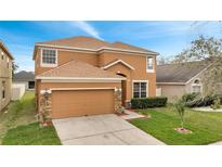 Charming two-story home with a well-maintained lawn and a two-car garage at 8722 Hastings Beach Blvd, Orlando, FL 32829