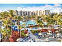 Expansive resort pool area surrounded by lush landscaping and comfortable lounge chairs, offering a relaxing vacation experience at 14501 Grove Resort Grove Resort Ave # 3733, Winter Garden, FL 34787