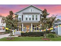 Charming two-story home with manicured front lawn, landscaping and colorful prayer flags at 149 E Muriel St, Orlando, FL 32806