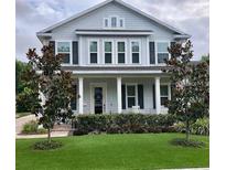 Charming two-story home featuring a welcoming front porch, manicured lawn and classic architectural details at 149 E Muriel St, Orlando, FL 32806