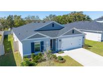 Attractive single-Gathering home with a manicured lawn, tidy landscaping and a convenient two-car garage at 1546 Park Leah Cir, Apopka, FL 32712