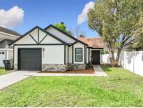 Charming single-Gathering home with a well-manicured lawn, black trim and an attached garage at 2229 Churchill Downs Cir, Orlando, FL 32825