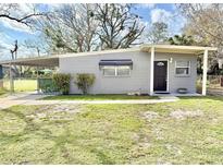 Charming single-story home featuring a covered carport, tidy landscaping and neutral color palette at 430 Pennsylvania Ave, Winter Garden, FL 34787