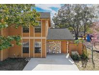 Charming two-story townhome with wood siding, stone accents, and a well-kept front yard at 486 Abba St, Altamonte Springs, FL 32714