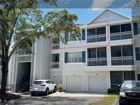 Exterior view of condo featuring screened balconies, attached garages, and traditional architectural details at 5017 City St # 1932, Orlando, FL 32839