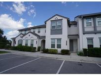 A two-story townhome featuring a well-maintained lawn and a convenient parking area at 510 Captiva Dr, Davenport, FL 33896