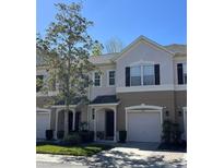 Charming townhome featuring a well-manicured lawn and attached one car garage at 554 Pinebranch Cir, Winter Springs, FL 32708