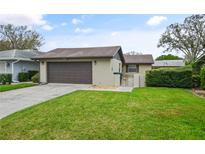 Charming home with a well-maintained lawn, inviting curb appeal, and a two-car garage at 620 Wexford Ct, Winter Haven, FL 33884