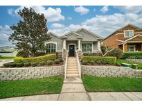 Charming single-story home with manicured lawn and stone accents, showcasing curb appeal and inviting entrance at 707 Brandy Oaks Loop, Winter Garden, FL 34787