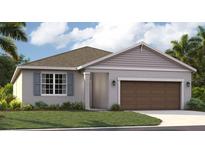Charming single-story home showcasing a well-manicured lawn and a two-car garage at 1132 Clay Blvd, Tavares, FL 32778