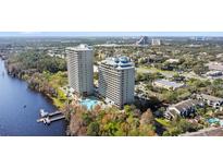 Beautiful aerial shot of the two high-rise buildings, lakefront, pool, landscaping, and surrounding area at 13415 Blue Heron Beach Dr # 610, Orlando, FL 32821