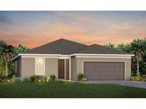 Beautiful single-story home with a well-maintained lawn, two-car garage, and neutral color palette at 1941 Spring Shower Cir, Kissimmee, FL 34744