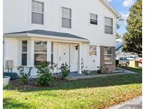 Charming two-story exterior with a well-maintained lawn, an inviting front door, and a bay window at 2413 Tack Room Ln # 2, Orlando, FL 32812