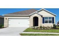 Charming single-Gathering home featuring a 2-car garage and well-manicured lawn at 2829 Jamaica Way, Haines City, FL 33844