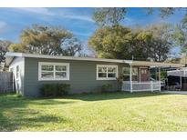 Charming single-story home with green siding, white trim, and a well-maintained lawn at 2942 Condel Dr, Orlando, FL 32812