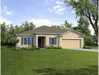 Well maintained single story home with neutral color palette, manicured lawn, and mature trees at 6552 Rhythm Dr, Mascotte, FL 34753