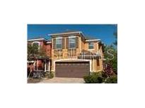 Two story home with brown roof, brown shutters, and a two car garage at 9575 Silver Buttonwood St, Orlando, FL 32832