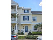 Charming townhome with cream siding, blue shutters and a well-manicured lawn at 136 Mcleods Way, Winter Springs, FL 32708