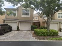 Inviting two-story townhome featuring a one-car garage and well-maintained landscaping at 2763 Metro Sevilla Dr # 108, Orlando, FL 32835