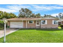 Charming single-story home with a well-maintained lawn and inviting curb appeal at 5715 Satel Dr, Orlando, FL 32810