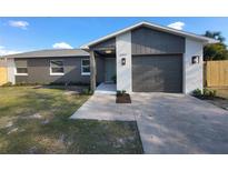 Charming home with a well-maintained lawn, updated color scheme, and an attached garage at 6809 Gallo Ct, Orlando, FL 32810