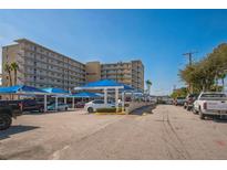 Harbor View condo complex with covered parking, lush landscaping and many parking spaces at 145 N Halifax Ave # 211, Daytona Beach, FL 32118