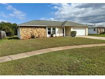 Charming single-story home featuring stone accents and a well-manicured lawn at 20517 Majestic St, Orlando, FL 32833