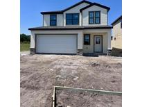 Charming two-story home with a two-car garage and unfinished front yard at 3171 Cup Dr, Lakeland, FL 33803