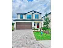 Two-story home with a two-car garage, neutral siding, and a manicured front lawn at 3171 Cup Dr, Lakeland, FL 33803