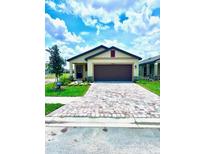 A charming single-story home with a brick paver driveway and well-manicured lawn at 3225 Cup Dr, Lakeland, FL 33803