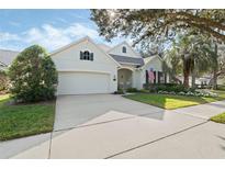 Charming single-Gathering home featuring a well-manicured lawn and a classic two-car garage at 325 Bellingrath Terrace, Deland, FL 32724