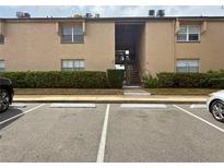 Neutral exterior of condo building with parking and stairs to units above the first floor at 370 N Windmeadows St # 370, Altamonte Springs, FL 32701