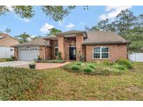 Charming brick home with a well-manicured lawn and lush landscaping at 10924 Dearden Cir, Orlando, FL 32817