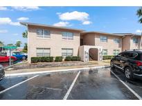 Condominium exterior featuring stucco, trimmed windows, and a lush landscape at 1170 Calle Del Rey # D, Casselberry, FL 32707