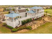 Stunning multi-story home with a unique spiral staircase and lush landscaping, perfect for outdoor living at 1432 Titian Ct, Reunion, FL 34747