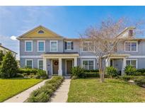 Charming two-story townhome with a well-maintained lawn and inviting front entrance at 15489 Honeybell Dr, Winter Garden, FL 34787