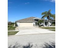 Well maintained, one-story home with a large driveway and a two-car garage at 1733 Weeping Elm Cir, Port Orange, FL 32128