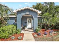 Charming home front door with detailed trim and a welcoming walkway and mature landscaping at 2909 Depauw Ave, Orlando, FL 32804