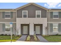 Charming townhome featuring neutral paint, complemented by a well-manicured lawn at 3962 Lana Ave, Davenport, FL 33897