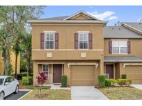 Charming two-story home with brown shutters and manicured landscaping, showcasing curb appeal at 4579 Lacebark Trl, Oviedo, FL 32765
