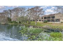 Beautiful waterfront condo with screened lanai overlooking lush vegetation and a community dock at 604 Desoto Dr, Casselberry, FL 32707