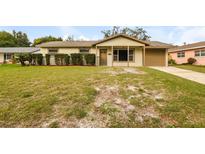 Inviting single-story home showcasing a well-manicured lawn and charming front porch at 615 Ellsworth St, Altamonte Springs, FL 32701