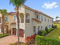 Beautiful two-story home with a barrel tile roof, two-car garage and well-maintained landscaping at 1064 Castle Pines Ct, Reunion, FL 34747