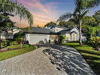 Beautiful home with a well maintained lawn, stunning brick driveway, and lush tropical landscaping at 1765 Torrington Cir, Longwood, FL 32750