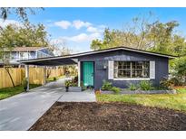 Charming home with a quaint yard, covered parking, and a delightful turquoise front door at 2715 Kilgore Street St, Orlando, FL 32803