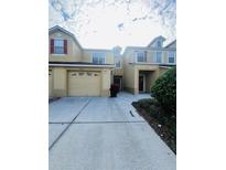 Townhome with attached garage and covered entryway at 2946 Ashland S Ln, Kissimmee, FL 34741